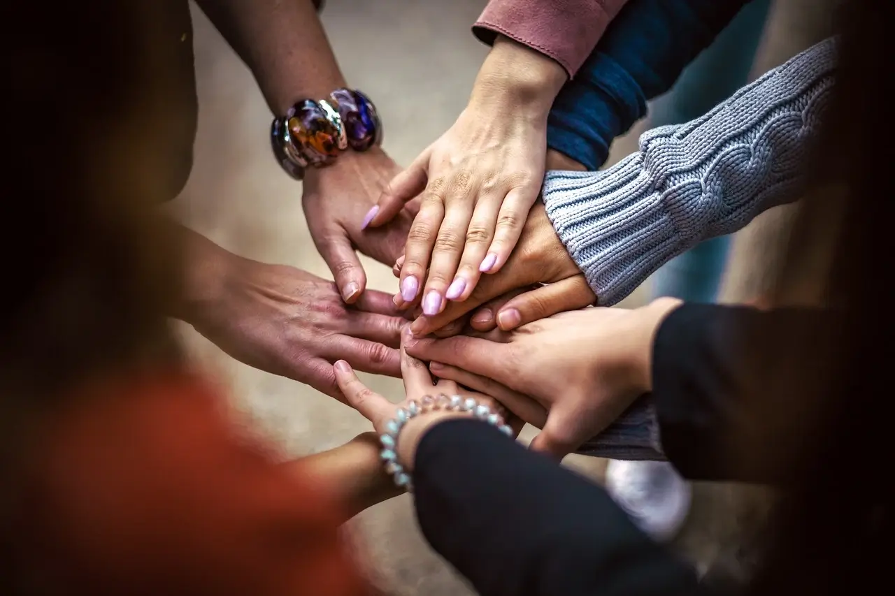 Volunteers joining hands in support of the community