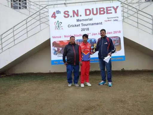 Tournament officials presenting an award to a young player