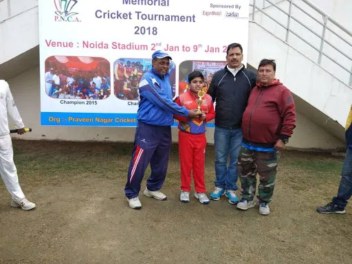 Young cricketer receiving the trophy at the 4th S.N. Dubey Memorial Cricket Tournament, 2018